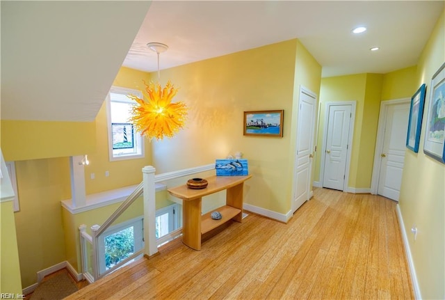 hallway with light hardwood / wood-style flooring