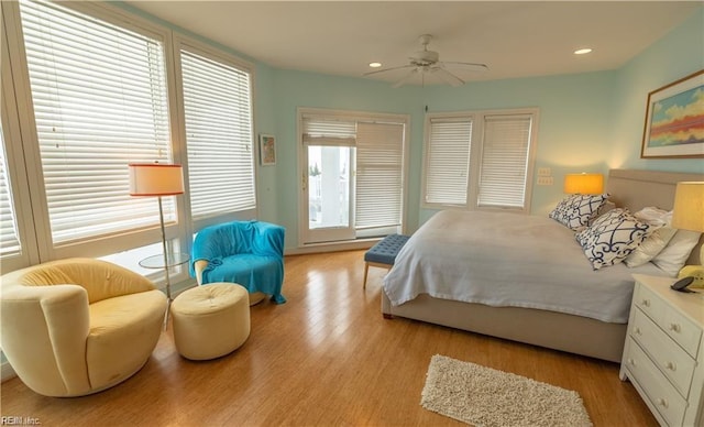 bedroom with ceiling fan and light hardwood / wood-style flooring