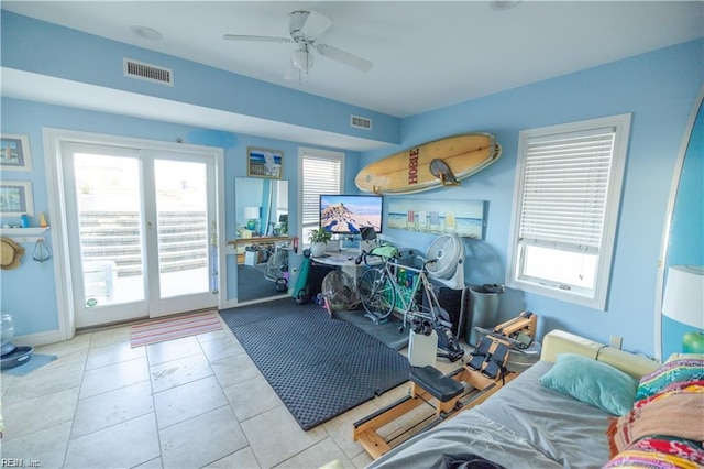 workout room with light tile patterned floors and ceiling fan