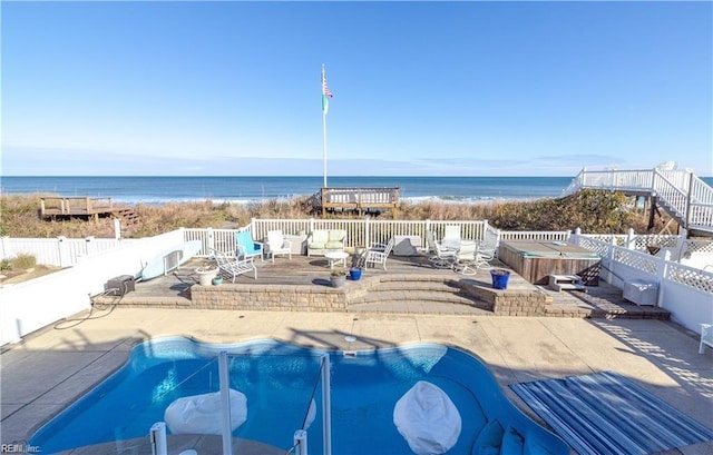 view of swimming pool with a deck with water view and a patio