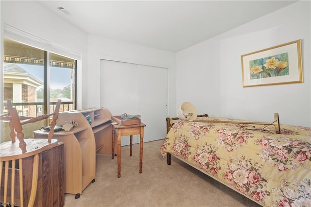 bedroom with light colored carpet and a closet