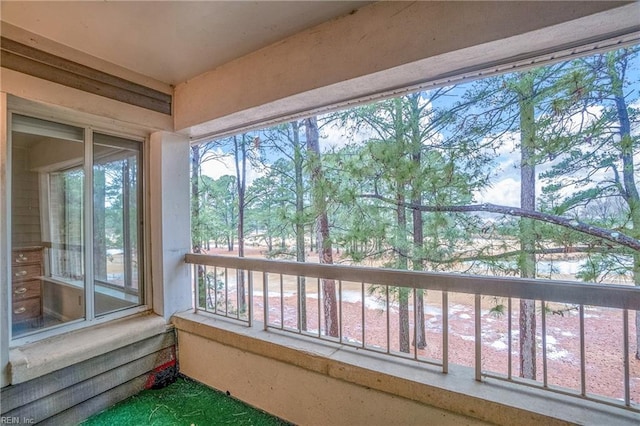 sunroom featuring a water view