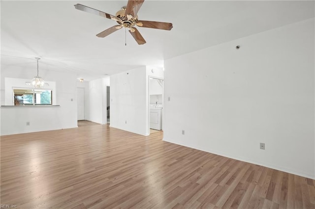 unfurnished living room featuring washer / dryer, ceiling fan with notable chandelier, and light wood-type flooring