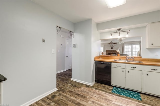 kitchen with a fireplace, white cabinetry, dishwasher, sink, and dark hardwood / wood-style flooring