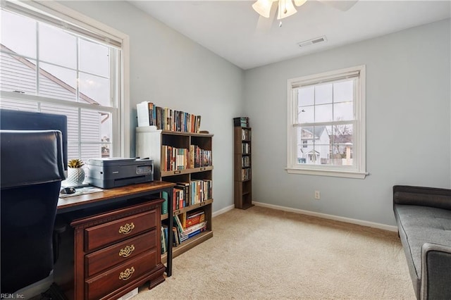 office area featuring light carpet and ceiling fan