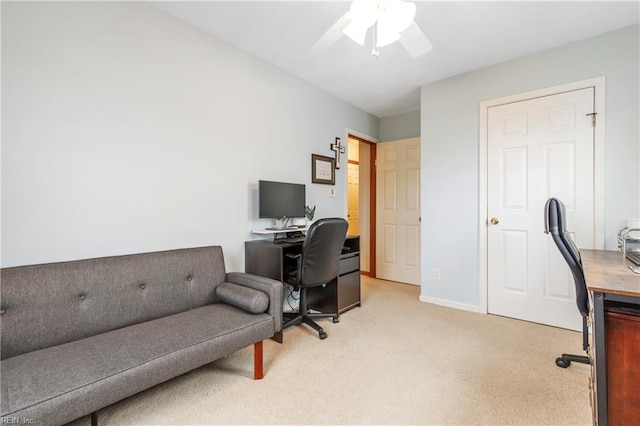 carpeted office space featuring ceiling fan