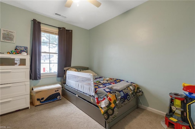 carpeted bedroom with ceiling fan and vaulted ceiling