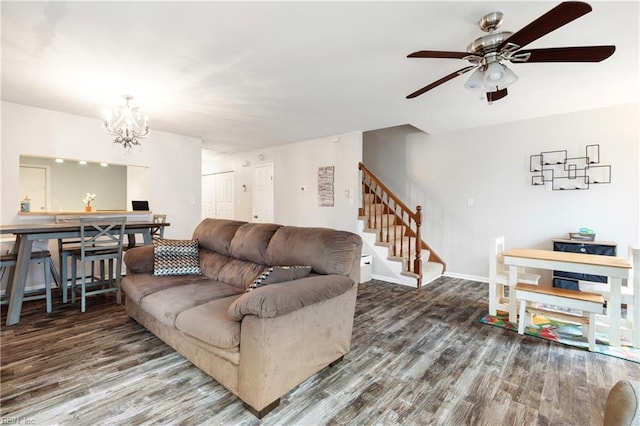 living room featuring hardwood / wood-style flooring and ceiling fan with notable chandelier