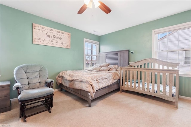 bedroom with light carpet and ceiling fan