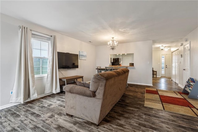 living room with dark wood-type flooring and a chandelier