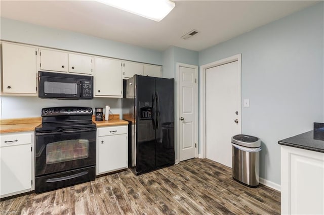 kitchen with white cabinets, dark hardwood / wood-style flooring, and black appliances