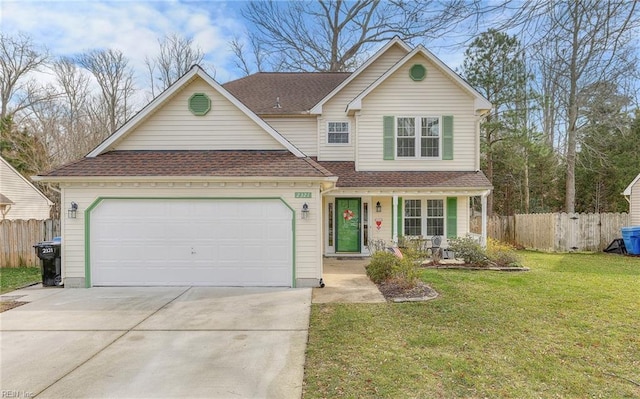 view of property featuring a garage and a front yard