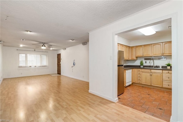 kitchen featuring light brown cabinetry, sink, light hardwood / wood-style floors, and dishwasher