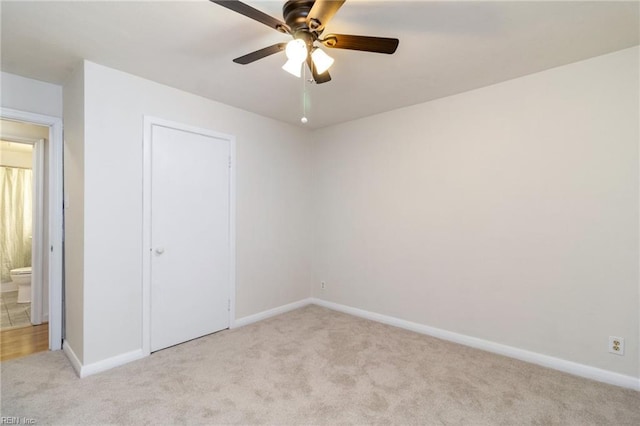 unfurnished bedroom with ceiling fan and light colored carpet