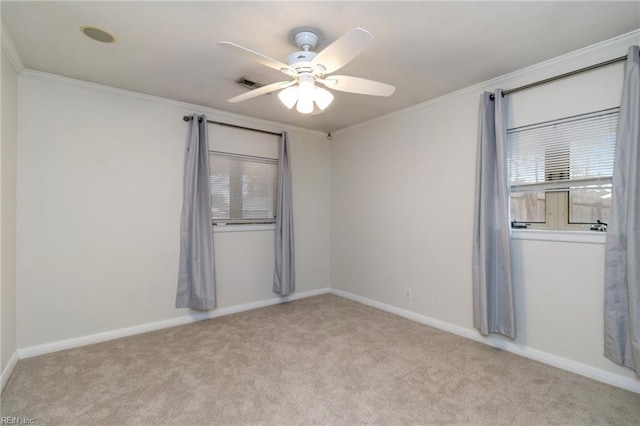 carpeted spare room with crown molding and ceiling fan