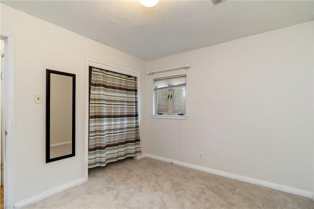 unfurnished room with light colored carpet