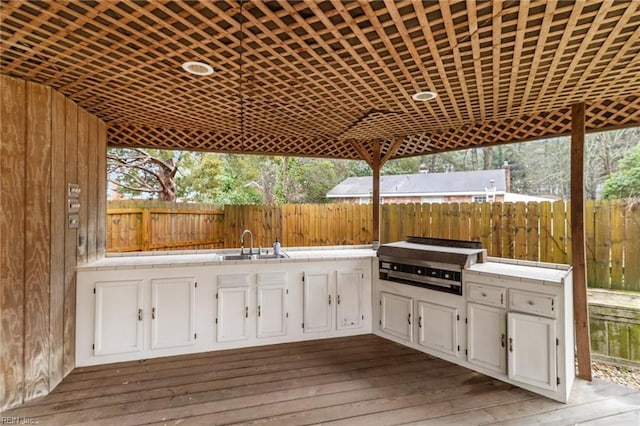 view of patio with an outdoor kitchen, a grill, and sink