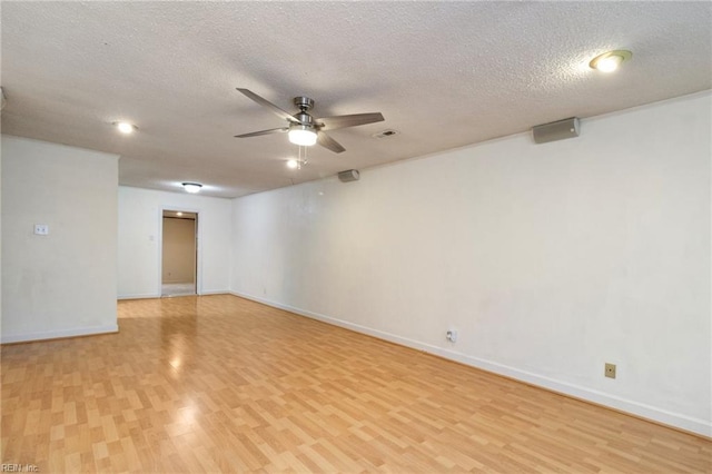 unfurnished room featuring ceiling fan, a textured ceiling, and light hardwood / wood-style floors