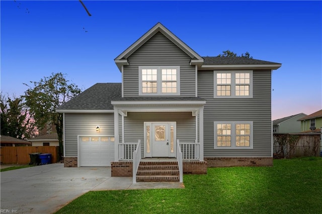 front of property featuring a garage and a yard