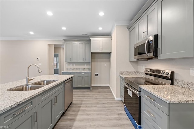 kitchen with sink, crown molding, stainless steel appliances, light hardwood / wood-style floors, and light stone countertops