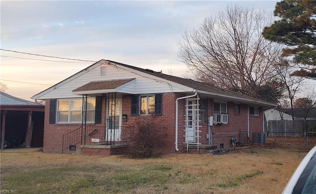 bungalow featuring a yard and central air condition unit