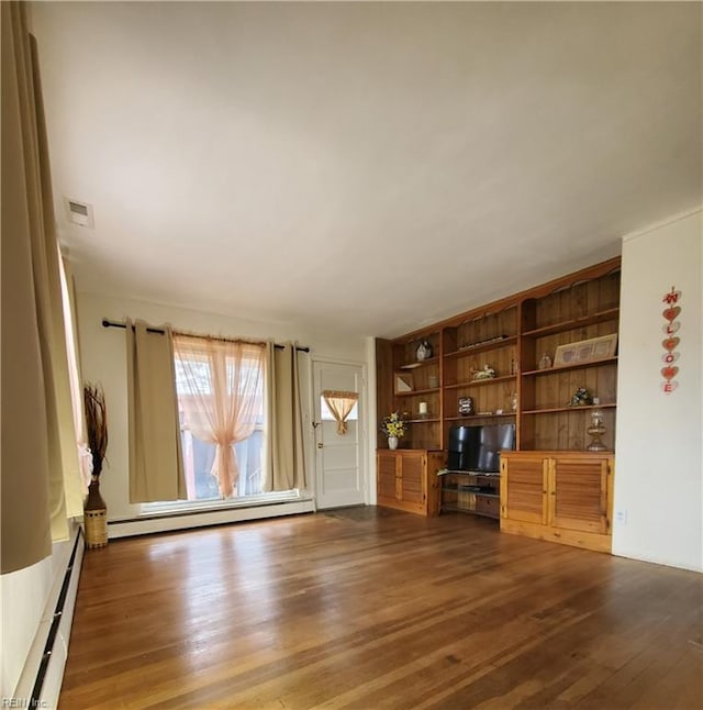 unfurnished living room featuring a baseboard radiator and dark hardwood / wood-style flooring