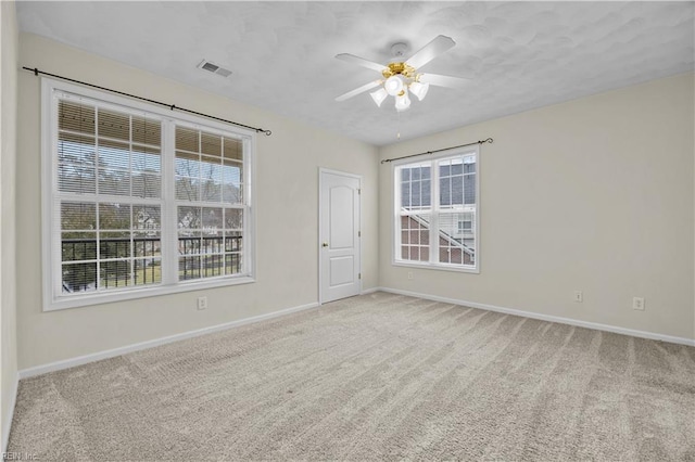 empty room with light carpet and ceiling fan