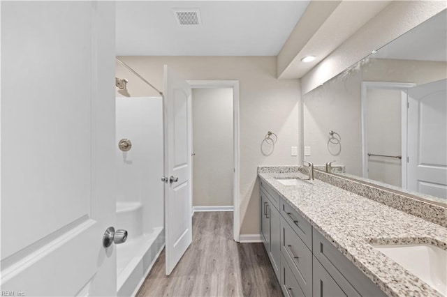 bathroom with vanity, hardwood / wood-style floors, and walk in shower