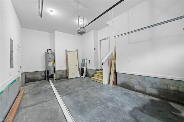 garage featuring a garage door opener, electric panel, and water heater