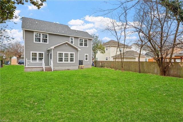 rear view of house featuring a yard