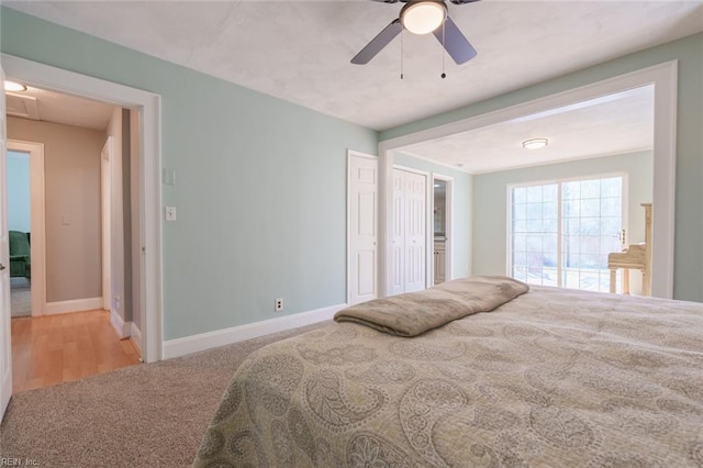 bedroom featuring ceiling fan and light carpet