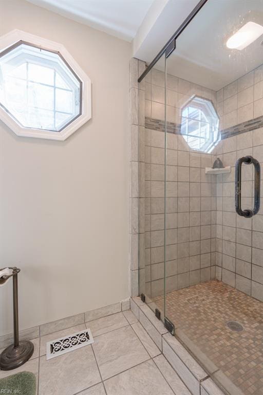 bathroom featuring tile patterned flooring and a shower with shower door