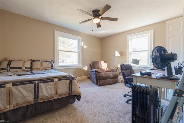 carpeted bedroom featuring multiple windows and ceiling fan