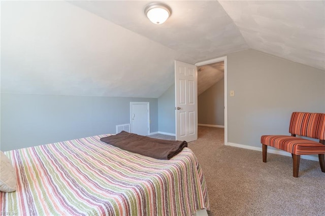 carpeted bedroom featuring lofted ceiling