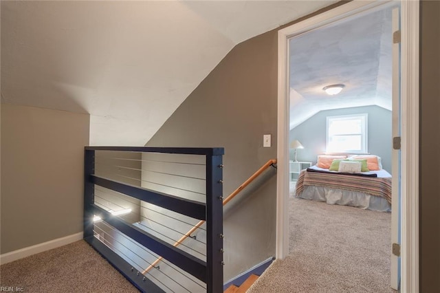 carpeted bedroom with lofted ceiling