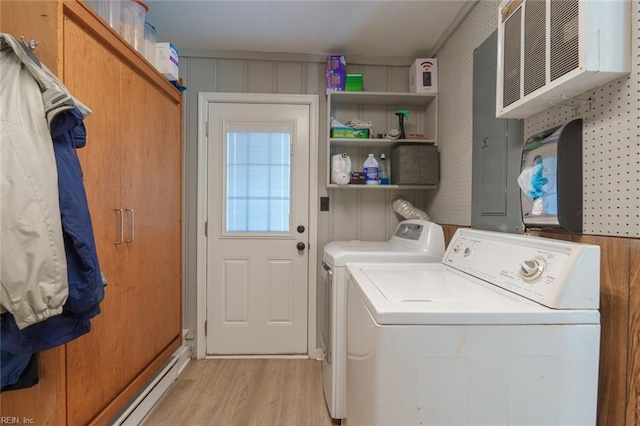 laundry room featuring washer and clothes dryer and light wood-type flooring