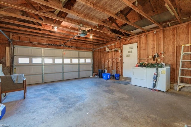 garage featuring washing machine and clothes dryer and a garage door opener