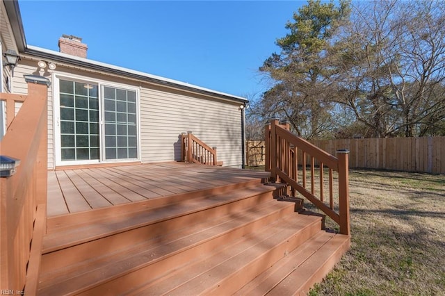 wooden deck featuring a yard