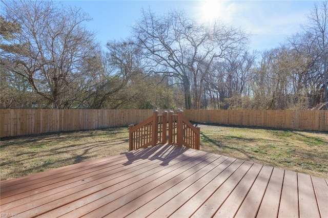 wooden terrace featuring a yard