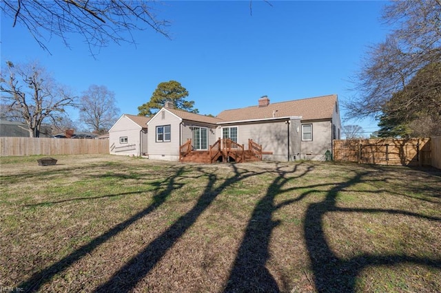 rear view of property with a lawn