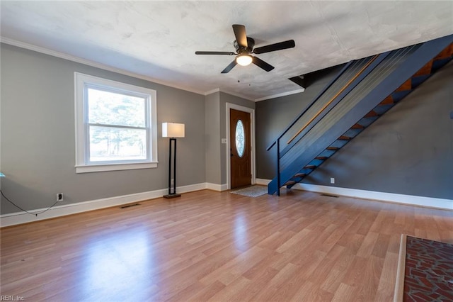 entryway with ornamental molding, ceiling fan, and light hardwood / wood-style flooring