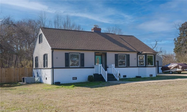 view of front of home with a front yard and central air condition unit