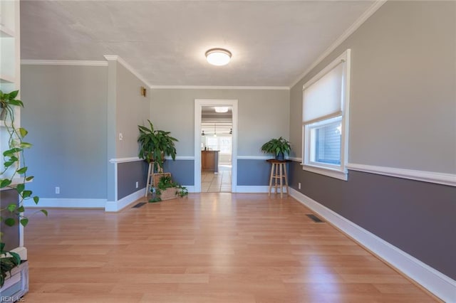 foyer entrance featuring ornamental molding and light wood-type flooring