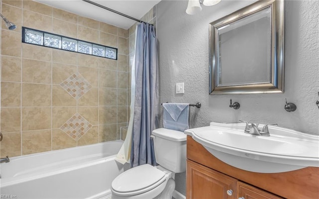 bathroom with shower / bath combo, a textured wall, vanity, and toilet