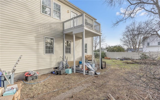 back of property featuring fence and a balcony