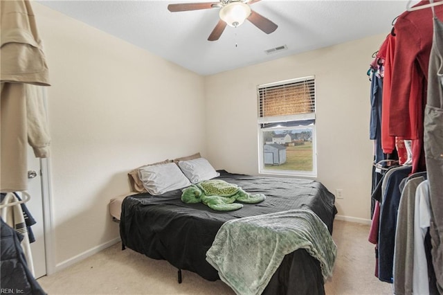 bedroom featuring ceiling fan and light colored carpet