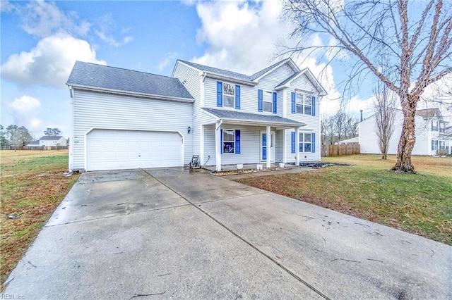 front of property featuring a garage, a front yard, and covered porch