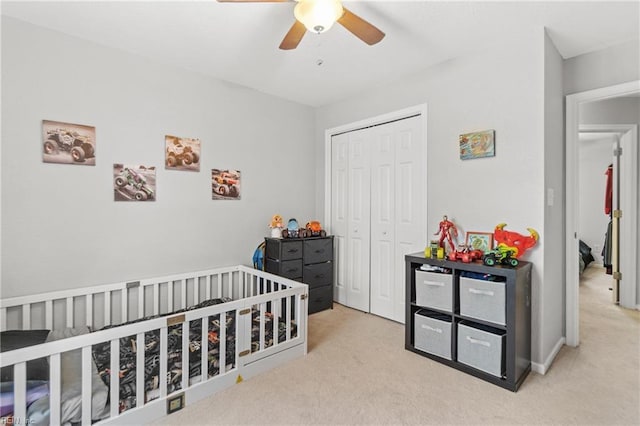 bedroom with light carpet, ceiling fan, and a closet