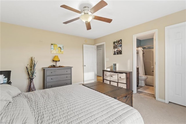 bedroom featuring ceiling fan, connected bathroom, and light carpet