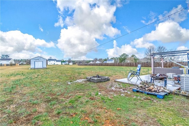 view of yard with a storage shed, a pergola, a patio area, and a fire pit